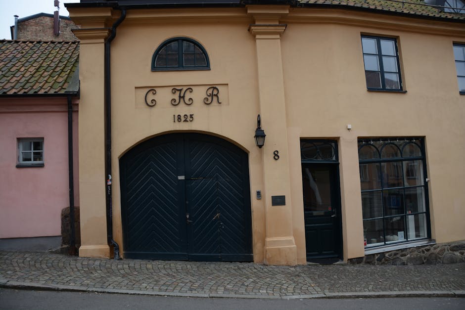 A historic building facade featuring 'CHR' and dated 1825 in a European street scene.
