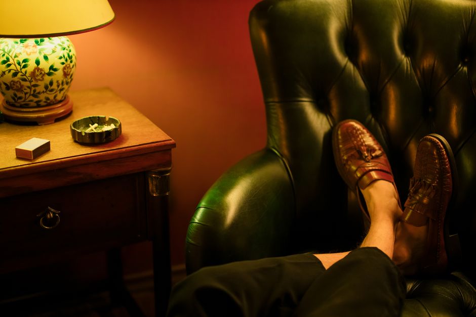 A relaxed evening setting with a stylishly decorated room featuring a leather chair and vi