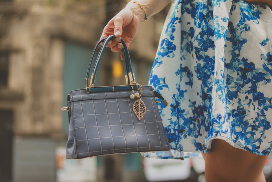 Elegant blue handbag and floral dress detail, perfect for fashion-forward styling on the go.