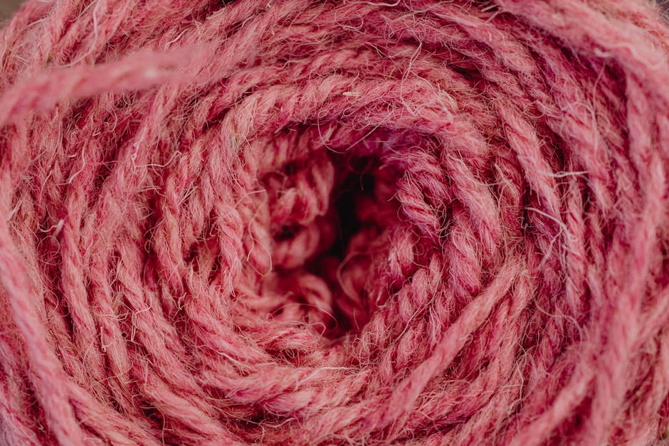 Detailed view of a coiled pink yarn showcasing texture and color.