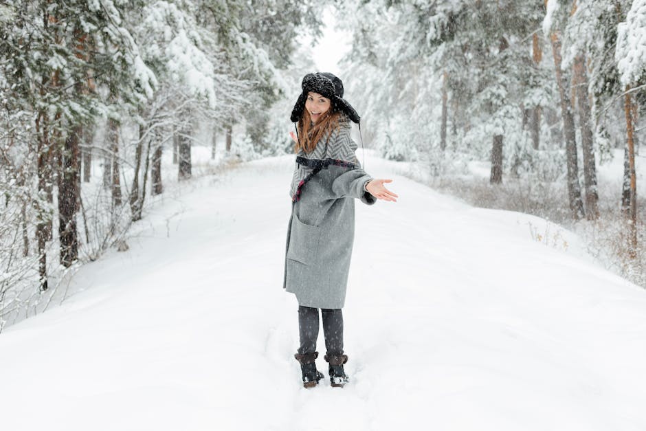 Woman smiling in a snowy Russian forest, dressed in winter attire with snow-covered trees around.