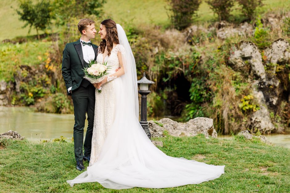 Charming wedding couple sharing a moment in a picturesque outdoor setting in Bușteni, Romania.