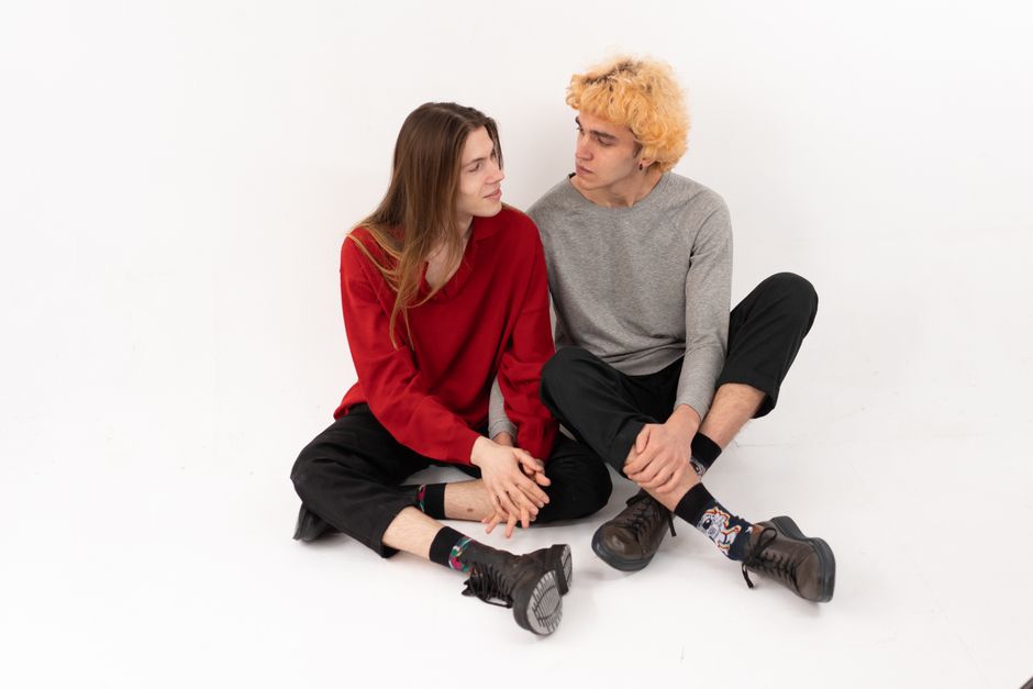 Young couple sitting closely, symbolizing love and companionship.