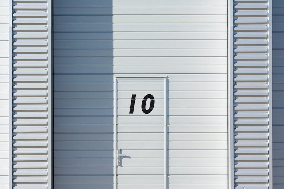 Sleek white metal wall with a numbered door, showcasing minimalistic design and industrial style.
