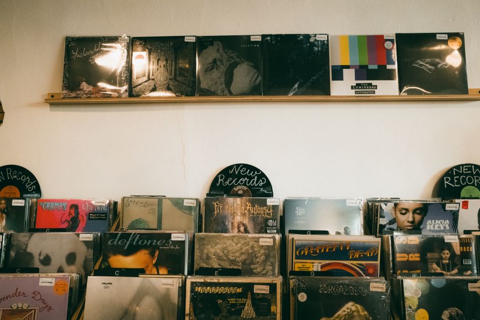 Vintage vinyl records neatly displayed in a cozy indoor record shop, ideal for music enthusiasts.